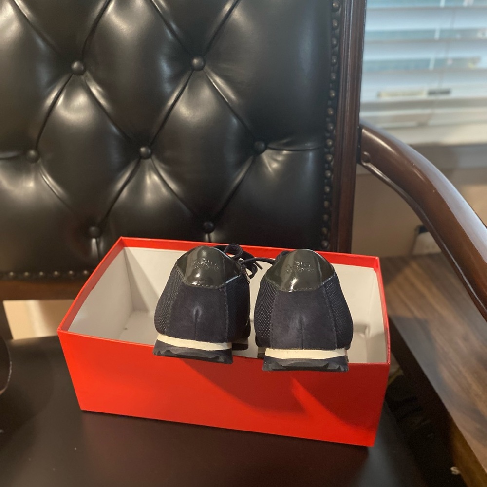 Navy blue coach sneakers.